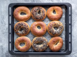nine bagels lined up in a pan