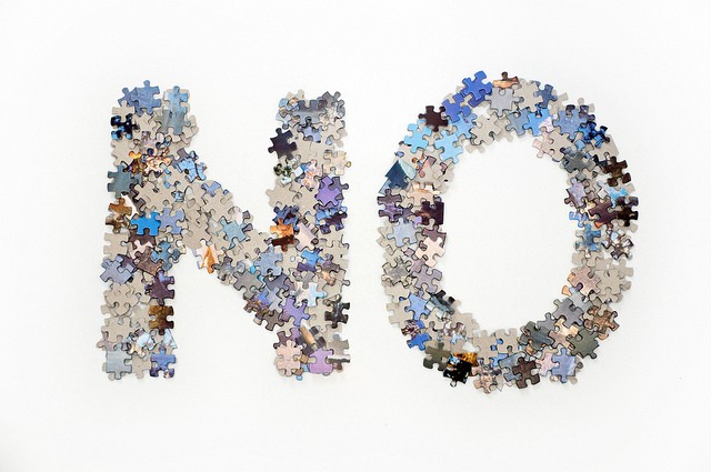 puzzle pieces in the shapes of the word no