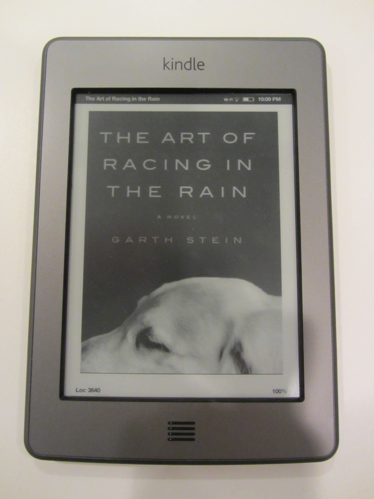 a picture of my kindle with the book the art of racing in the rain