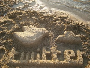 twitter logo in sand