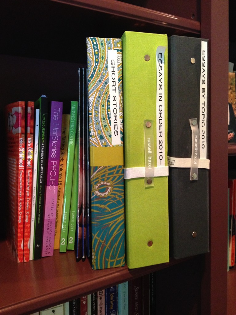 My writing shelf with three binders and books 