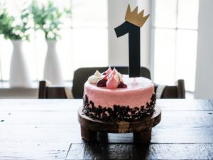 pink birthday cake with a one and a crown